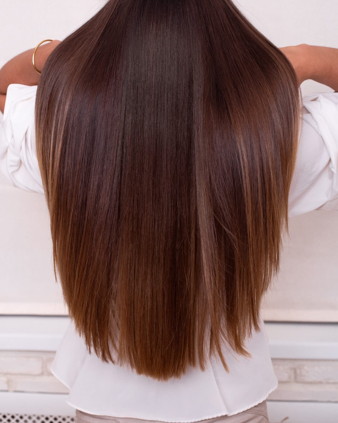 Woman demonstrates beautiful, healthy hair without split ends