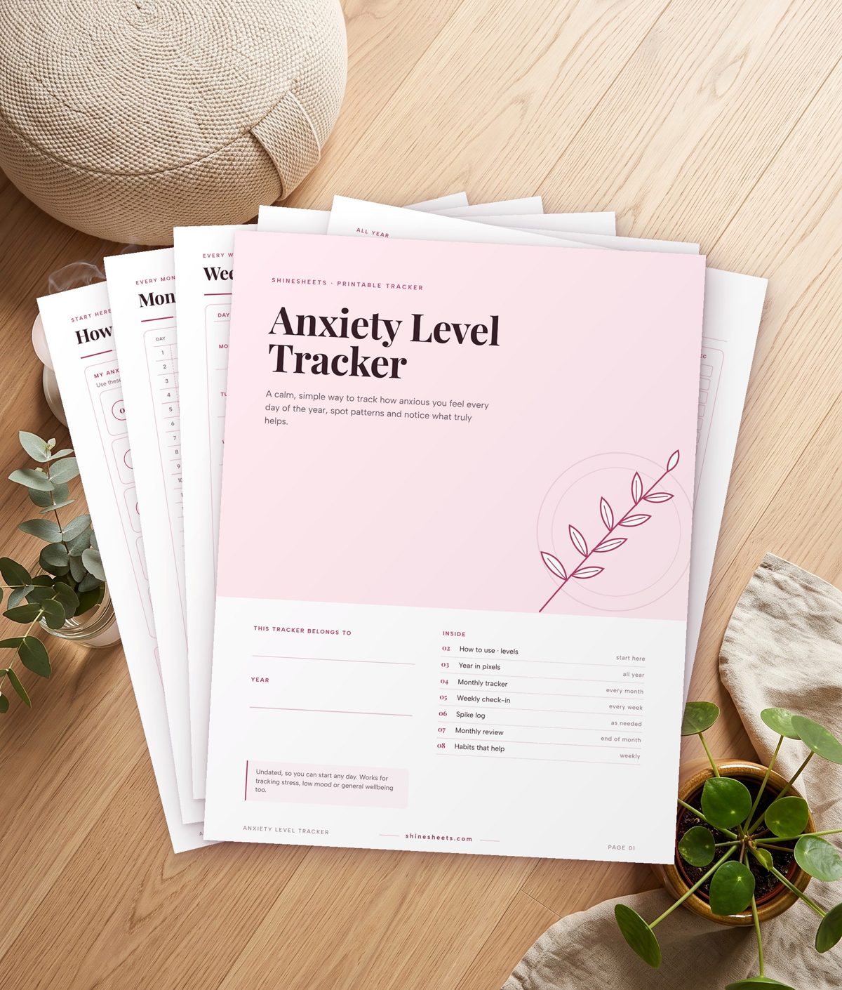 Printable anxiety level tracker cover and pages on a table