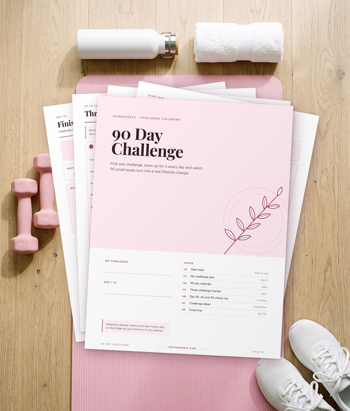 Printable challenge tracker cover with pages fanned out