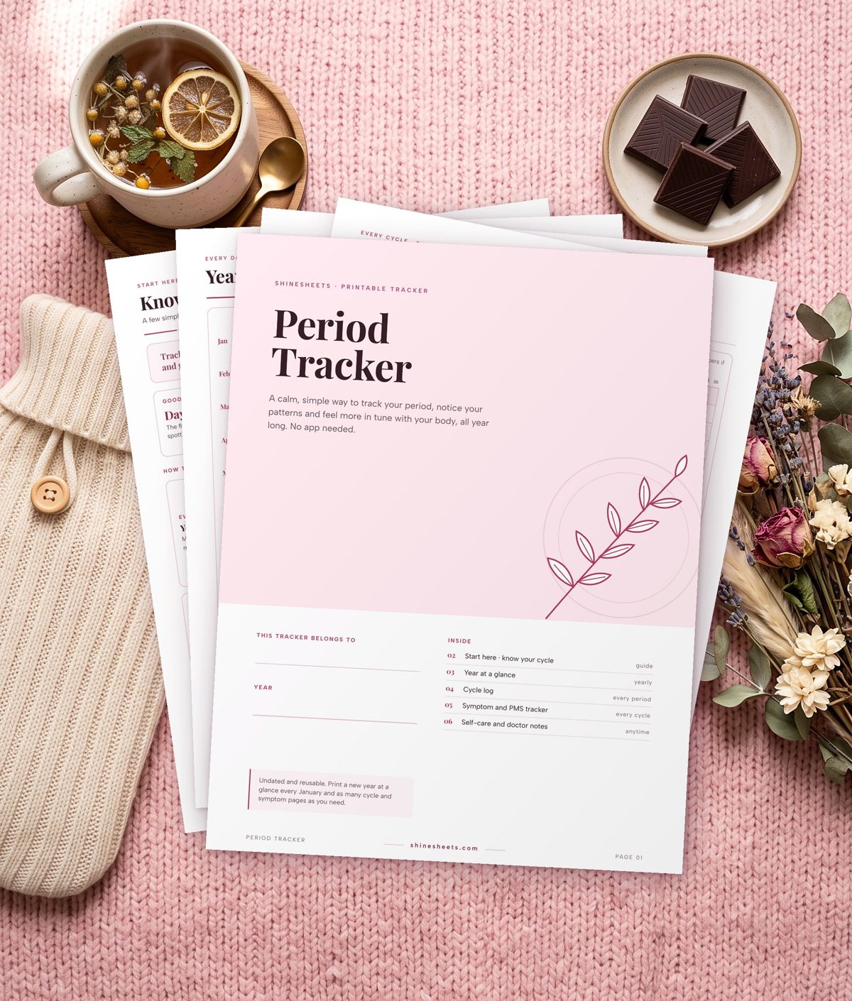 Free printable period tracker with cover and pages on a pink blanket